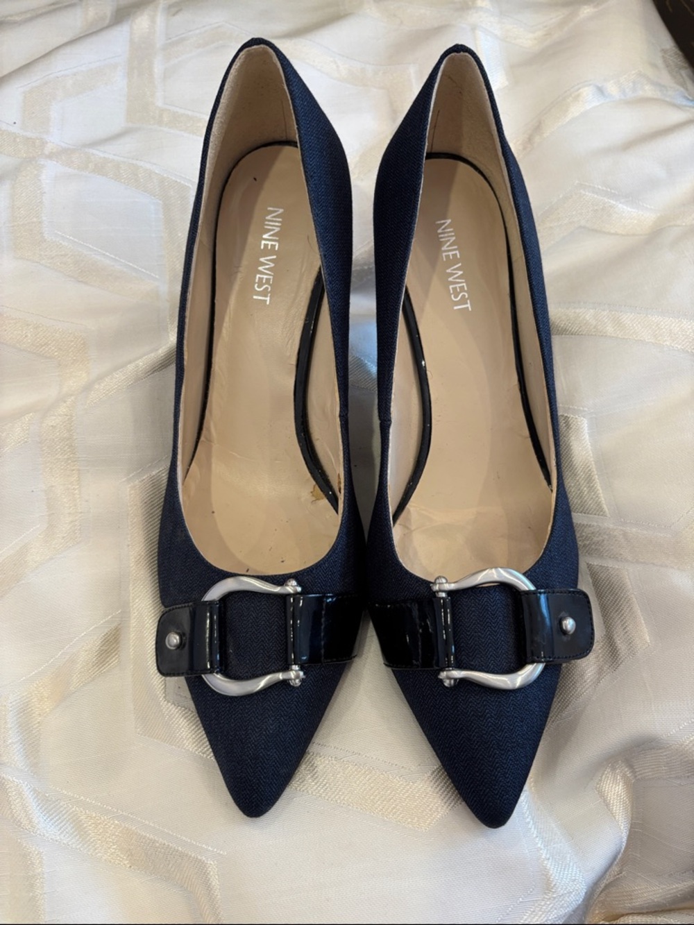 Nine West navy pointed-toe pumps with patent buckle detail